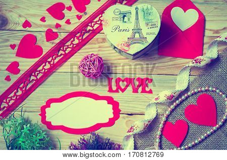 Hearts flowers ribbons on a wooden light background