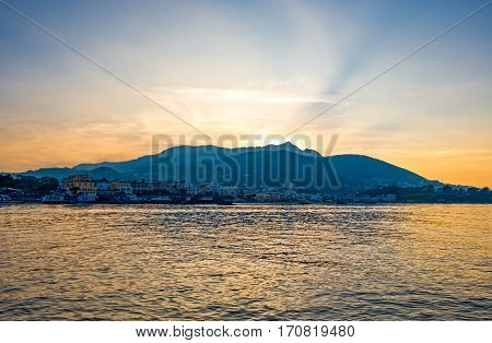Italy Ischia sunset view of the coast with Ischia Ponte village