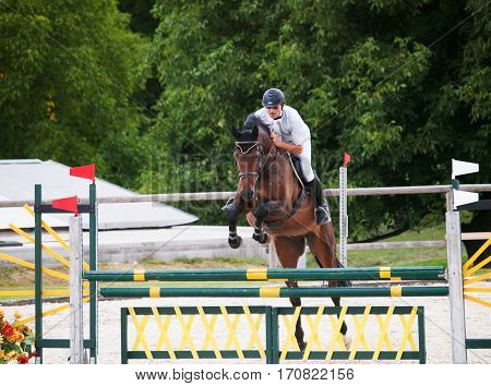 Horse with rider jump over the hurdle during competition