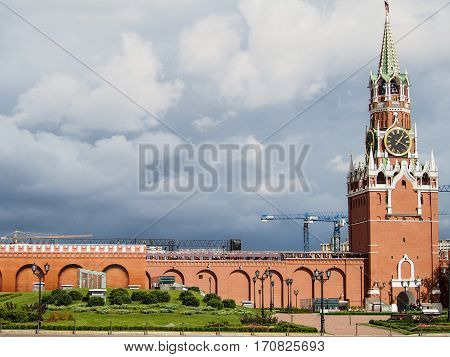 A part of the red wall and tower of the Kremlin in downtown Moscow Russia on a cloudy day.