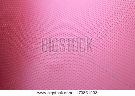 the texture of the paper sheet red-crimson color with volumetric texture points. Abstract soft focus. Background mode