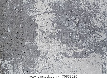 old gray concrete wall with peeled stucco