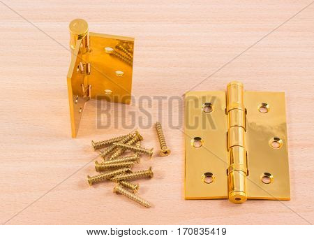 hinges on a wooden background gold color metal