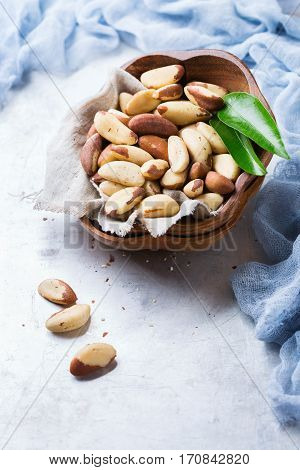 Still life, food and drink, heathy nutrition concept. Portion of organic healthy brazil nuts on a rustic table, selenium source. Copy space background