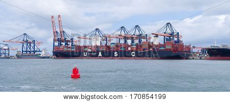ROTTERDAM NETHERLANDS - MAY 14 2016: UASC Container ship being unloaded in the rotterdam port. United Arab Shipping Company owns and operates a fleet of 52 ships