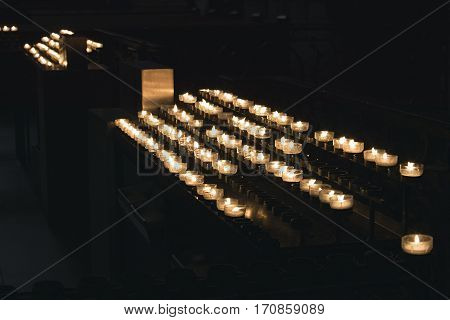 Germany, Cologne- March, 2016 A lot of burning candles in candlesticks are in the cathedral