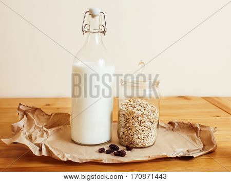 real comfort wooden kitchen with breakfast ingredients close up in glass, honey, oatmeal, milk, muesli, morning food