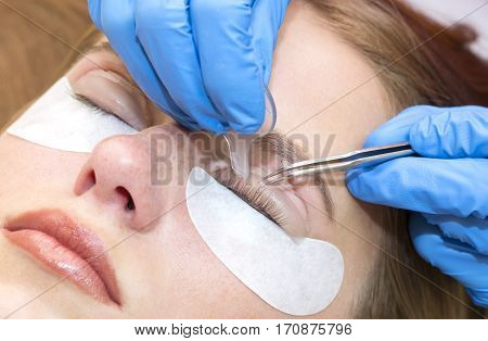 Woman on the procedure for eyelash extensions, eyelashes lamination
