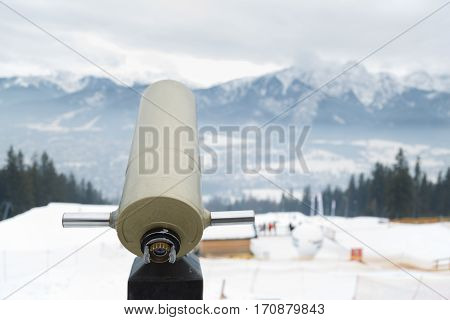 Panoramic telescope with mountain views in winter