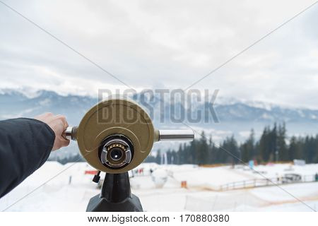 You can use the monocular to look to the mountains