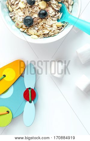 concept kid breakfast with muesli top view on white background.