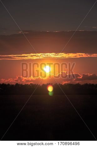 Orange Sun Sets In Beautiful Cumulus Clouds. Iidyllic Countryside Landscape