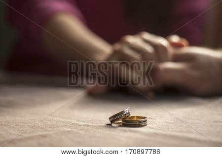 Love, Valentine`s Day And Wedding Concept. Two Wedding Rings With Man And Woman Hands Blurred In The
