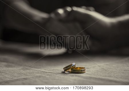 Love, Valentine`s Day And Wedding Concept. Two Wedding Rings With Man And Woman Hands Blurred In The