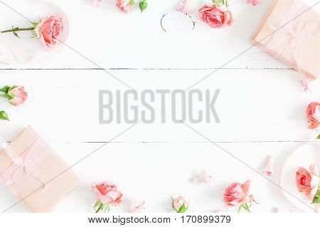 Flowers composition. Gifts and rose flowers on white wooden background. Valentine's Day. Flat lay top view