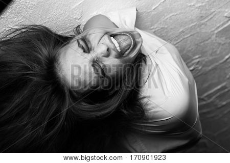 screaming crazy fun woman in straitjacket, monochrome