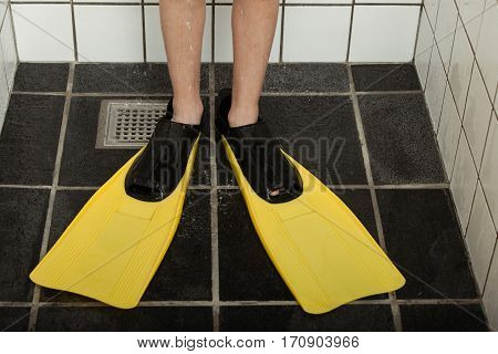 Pair Of Diving Flippers On Feet In Shower Stall