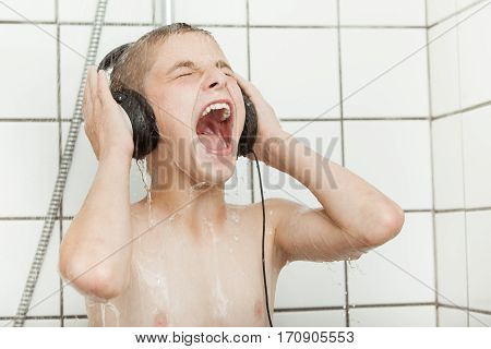 Singing Child With Earphones In Shower Stall