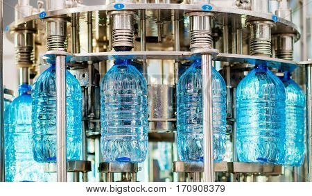 Filling pure bottles with mineral water at a factory
