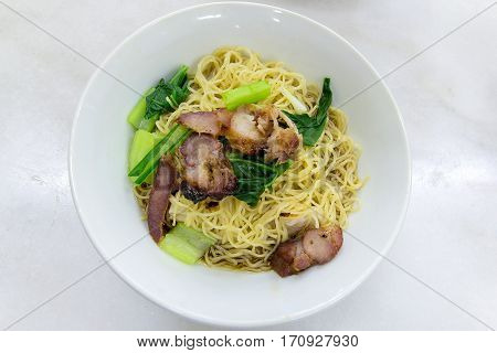 Char Siew Barbecue Pork Wanton Noodles with green vegetable dried version closeup macro