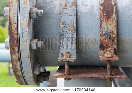 Dirty cast iron saddle clamp for steel pipe connect from pump into the lake within public park