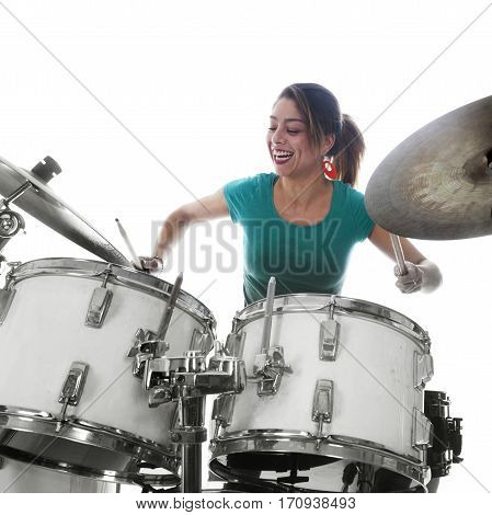brunette brazilian woman has fun playing the drums in studio against white background