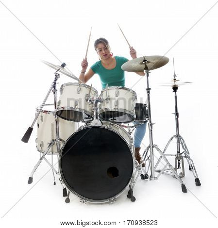 brunette brazilian woman concentrates on playing the drums in studio against white background
