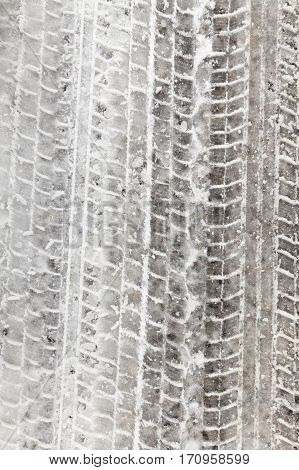 Tracks And The Track Of The Car Left In The Snow. On The Surface Of Visible Dirt. Photo Close Up In 