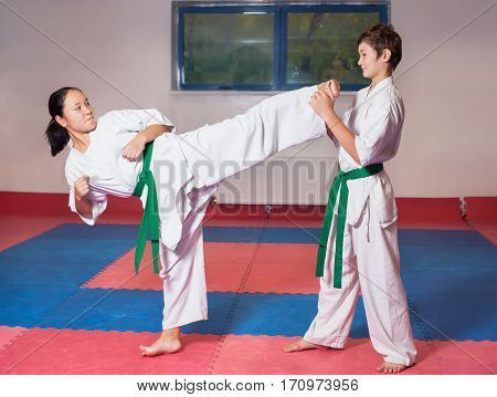 Children during training in karate. Fighting position active lifestyle practicing fighting techniques