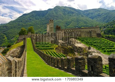 Perspective view of Murata - old city fortifications and Castelgrande castle in background. City wall of Bellinzona Ticino Switzarland