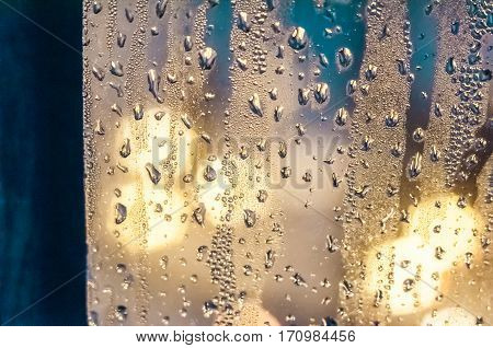 Condenced water drops on a blurred background with lights