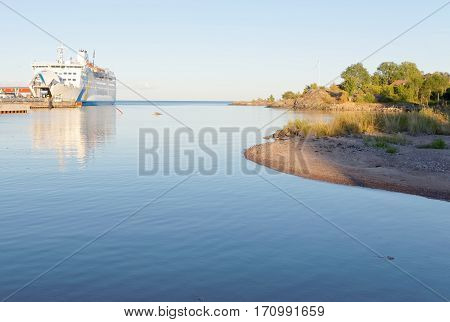 GRISSLEHAMN SWEDEN - JUL 12 2016: PPassenger ferry in the harbor and blue calm water sea in the swedish archipelago. July 12 2016 Grisslehamn Sweden