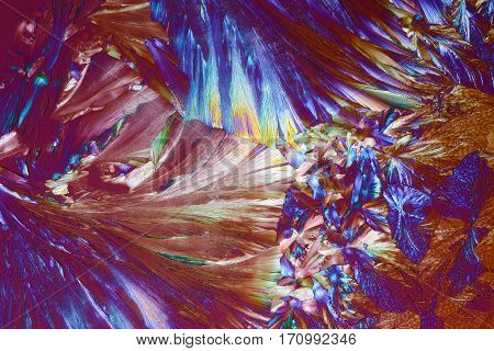 Colorful micro crystals through the microscope in polarized light