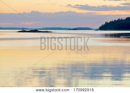 Sunset in the swedish archipelago pale orange and violet colors