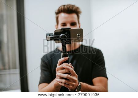 Man holding a gimbal with a phone