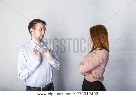 Young Husband Is Deceiving His Wife, His Wife Looks At Him Reproachfully And Does Not Believe Him. F