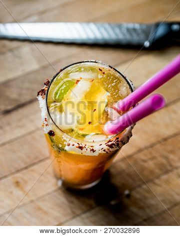 Mexican Michelada Cocktail With Beer, Lime, Ice And Spices..