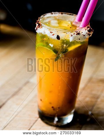 Mexican Michelada Cocktail With Beer, Lime, Ice And Spices..
