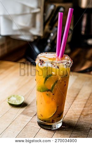 Mexican Michelada Cocktail With Beer, Lime, Ice And Spices..