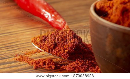 Red Paprika , Powder, In Wooden Backgrond Close Up
