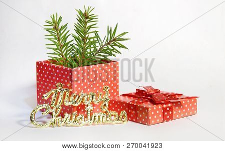 Gift Red Box In White Polka Dots With Bow Branches Christmas Tree Gifts Toy Ball On White Background