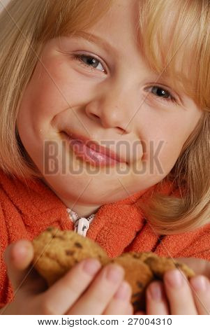 Little girl eating cookies,kid holding cookies.