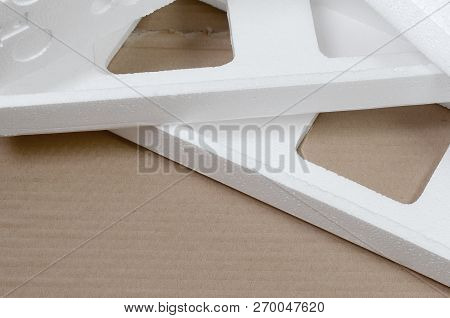 Background Image With Beige Cardboard Paper And Styrofoam Boxes Disgarded As Rubbish. The Concept Of
