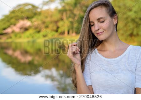 Close Up Of Beautiful Woman With Long Hair Thinking Against Scen
