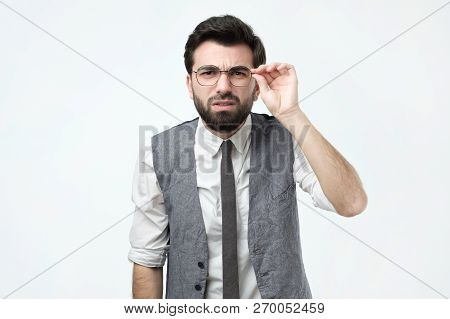 Funny Good Looking Skeptical Man In Glasses Looking At Camera