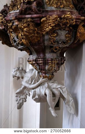 WEINGARTEN, GERMANY - JULY 12, 2018: The pulpit carrying angel, pulpit in the Basilica of St. Martin and Oswald in Weingarten, Germany