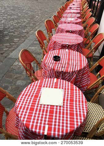 Typical cafehouse tables and chairs on a street in Paris