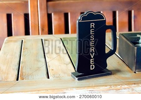 Beer Pinta Reserved Sign On Wooden Table In Pub, Cafe, Restaurant. Order Lunch, Dinner, Breakfast In