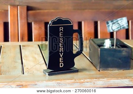 Beer Pinta Reserved Sign On Wooden Table In Pub, Cafe, Restaurant. Order Lunch, Dinner, Breakfast In