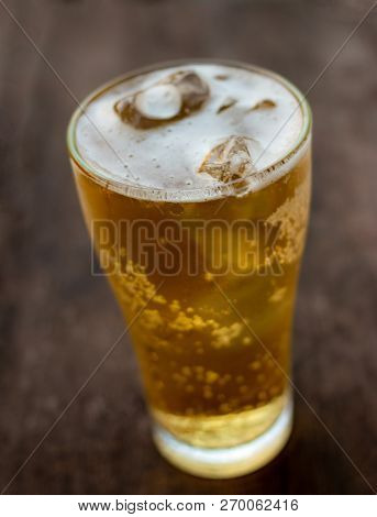 Glass Of Beer On Old Wooden Background